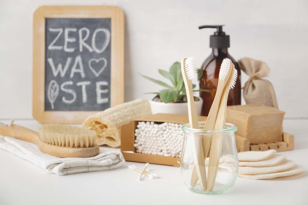 Zero waste, Recycling, Sustainable lifestyle concept. Eco-friendly bathroom accessories: toothbrushes, reusable cotton make up removal pads, make up remover in a glass container, natural brushes, handmade soap, bamboo ear sticks