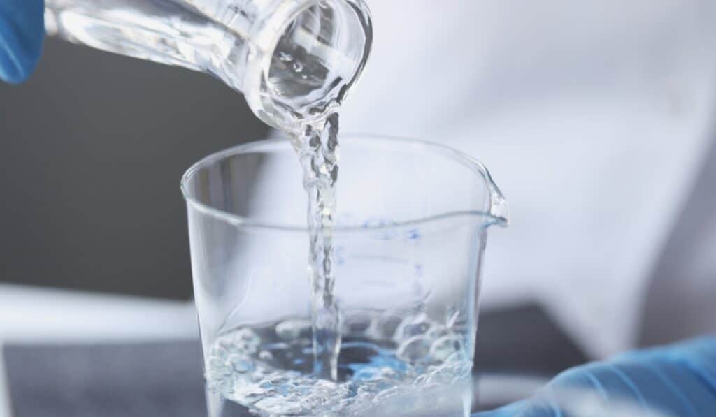 pouring water in lab cup