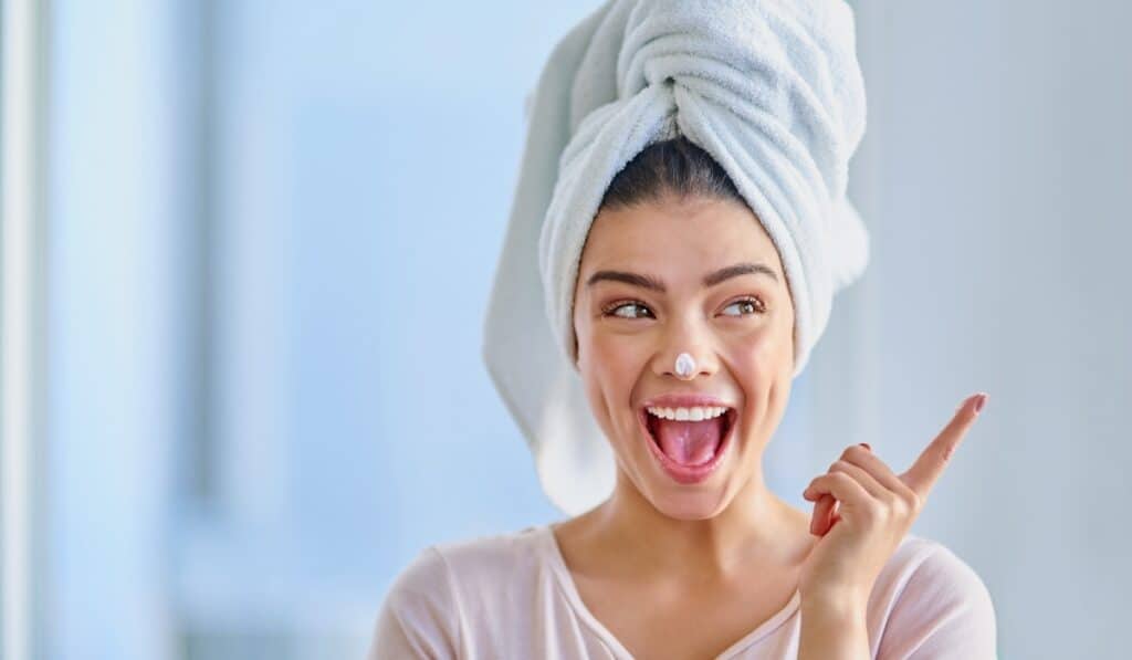 woman smiling with towel on her head