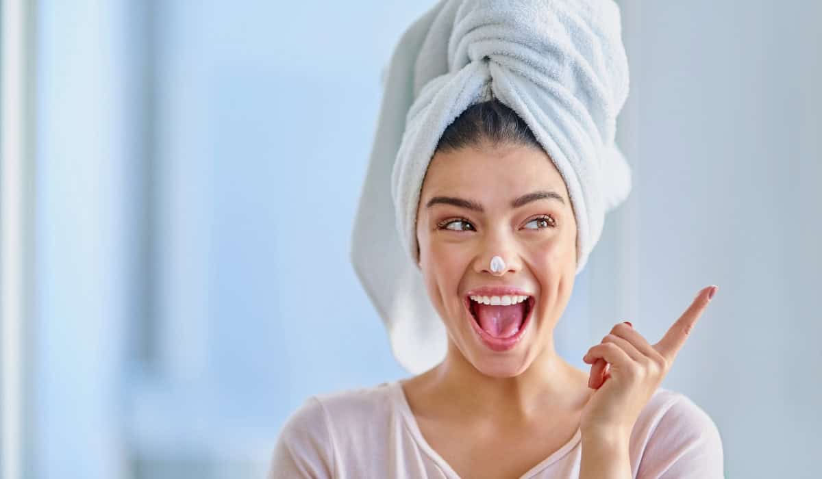 woman smiling with towel on her head