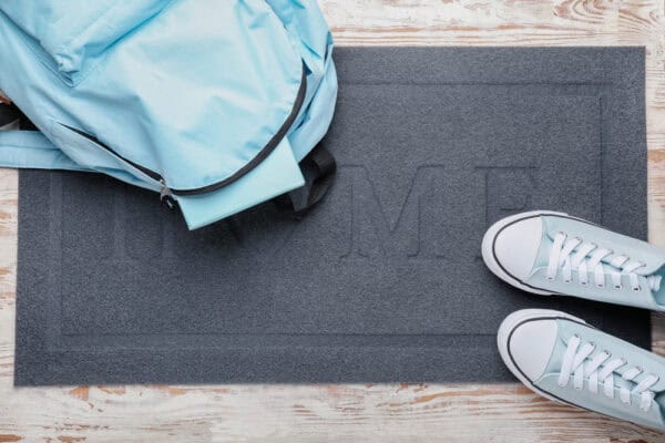 doormat with shoes and backpack
