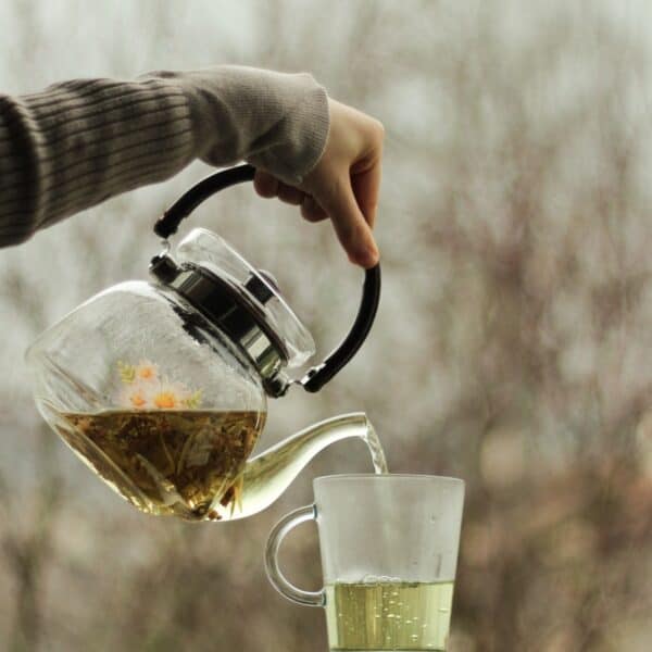 pouring tea into glass mug